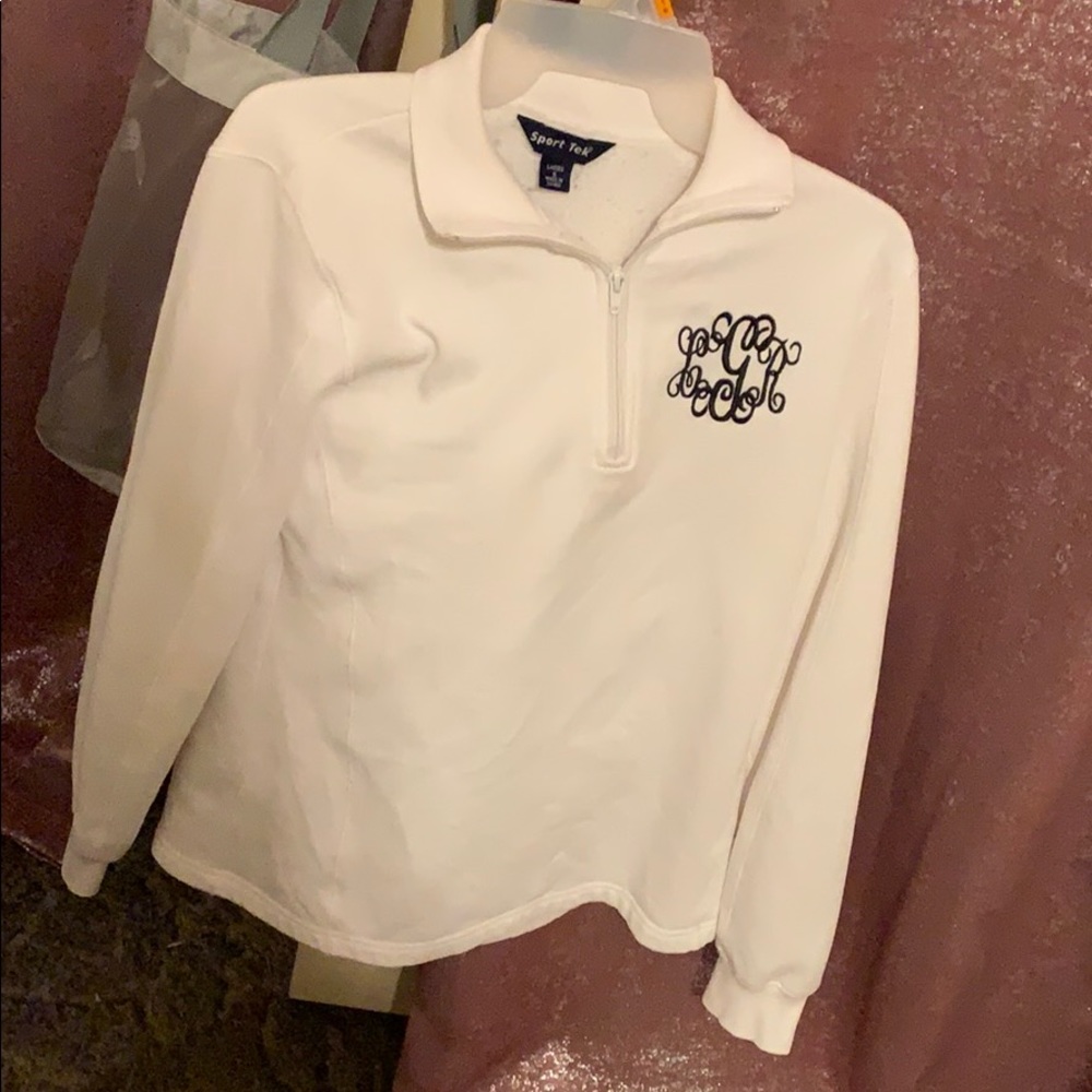 White pullover with initials “cGr” embroidered